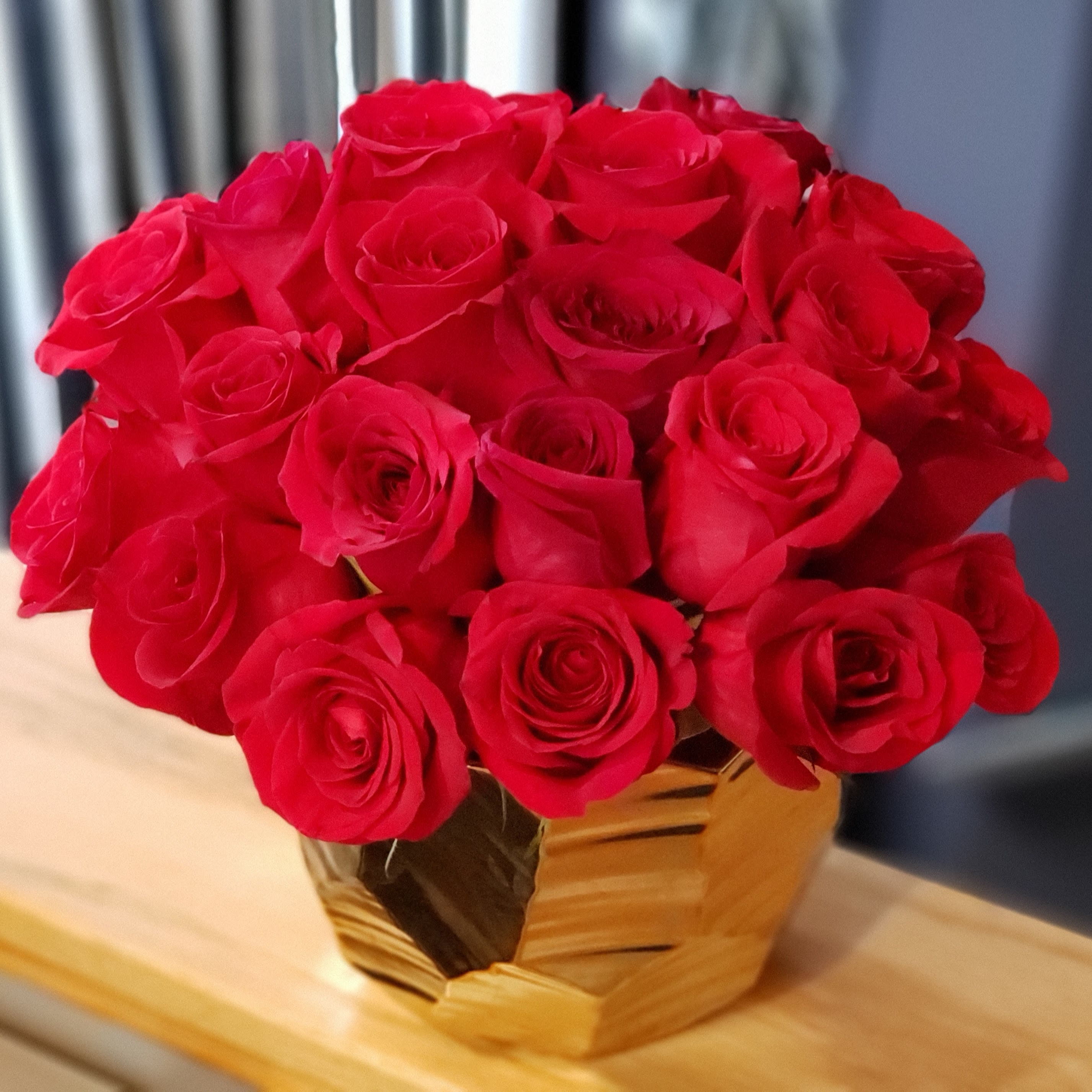 24K - 24 velvet red roses in a gold container