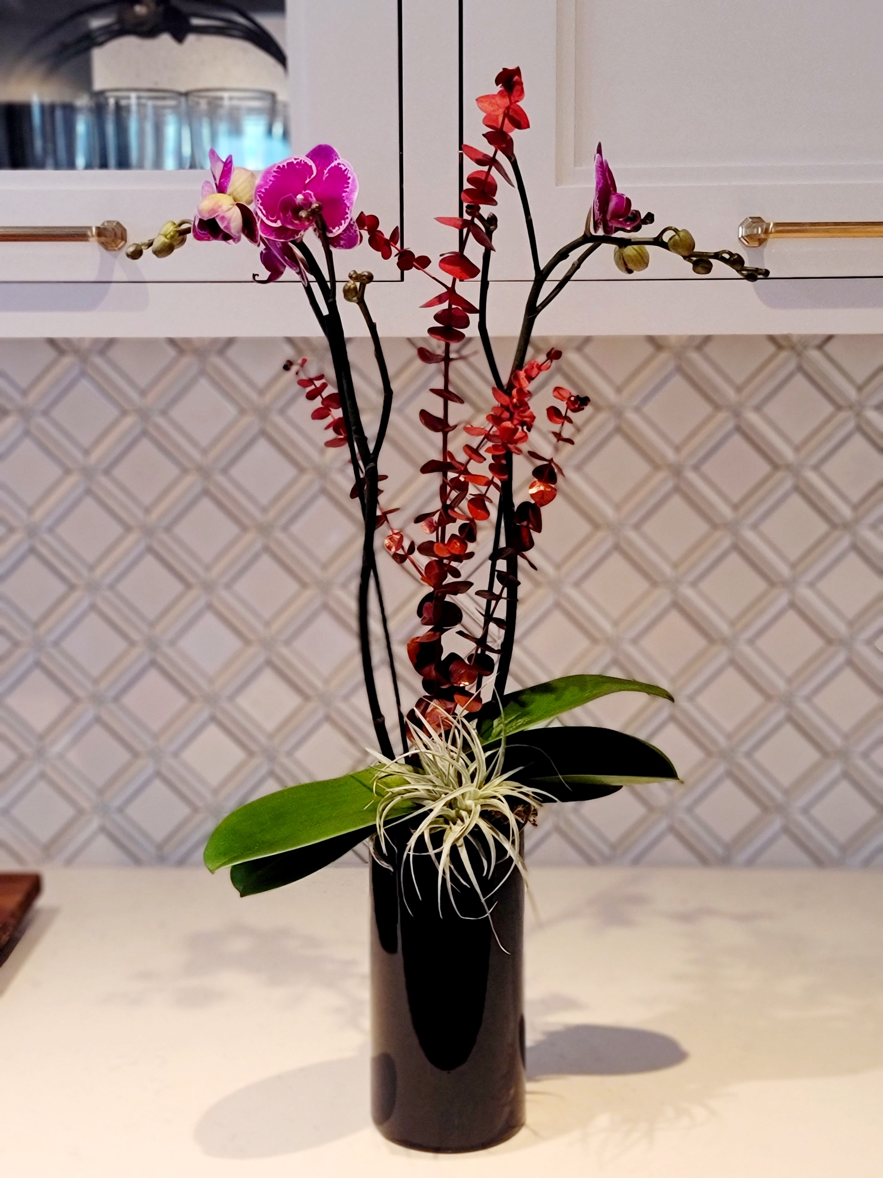 KP Love  - Double phalaenopsis orchids with eucalyptus &amp; air plant in a tall cylinder. 