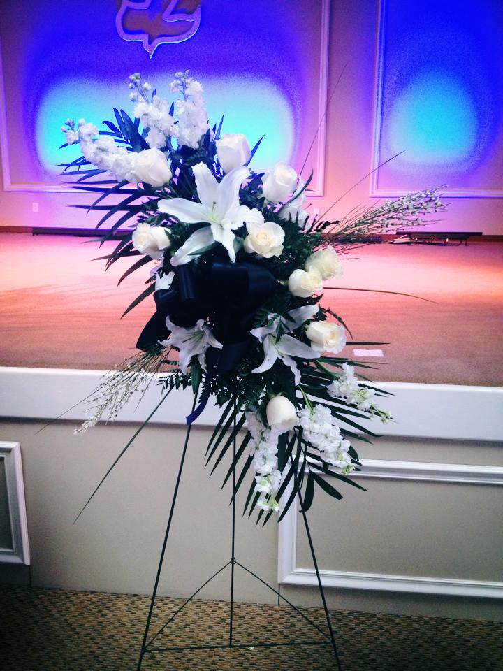 Funeral Standing Spray - An artistic creation for Funeral Tribute. Show your Love and Respect with this elegant gorgeous Funeral Flowers.Combination of sophisticated flowers. Big and Beautiful Standing Sprays, Sympathy Flowers. This sympathy arrangement has Big Oriental White Lilies, White Roses, White Stock With Green Palm Leaves and other Fresh Greens. Comes with 54&quot; Tall Stand. Flower Arrangement apx. size 40&quot; H x 28&quot; W. Upgrade to deluxe or Premium for More Flowers. Call for special Request in Color or Flowers. All our Designs are custom made and fresh delivered on time.