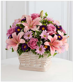 The FTD® Loving Sympathy™ Basket - The FTD® Loving Sympathy™ Basket is a wonderful way to convey your condolences for their loss. Lavender roses, pink Asiatic lilies, lavender daisies, purple matsumoto asters, green hypericum berries and lush greens are sweetly arranged in a square whitewash basket to create a lovely way to offer your caring kindness during this trying time. GOOD basket includes 14 stems. Approximately 14&quot;H x 16&quot;W. BETTER basket includes 19 stems. Approximately 15&quot;H x 17&quot;W. BEST basket includes 24 stems. Approximately 16&quot;H x 20&quot;W. Your purchase includes a complimentary personalized gift message.