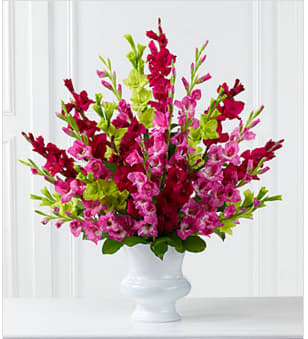 The FTD® Solemn Offering™ Arrangement - The FTD® Solemn Offering™ Arrangement is a bright and beautiful way to say your final farewell. Fuchsia, magenta and jade gladiolus are accented with lush greens and displayed in a white plastic urn to commemorate the life of the deceased wtih fantastic color and elegance. GOOD arrangement includes 25 stems. Approximately 34&quot;H x 34&quot;W. BETTER arrangement includes 31 stems. Approximately 35&quot;H x 35&quot;W. BEST arrangement includes 37 stems. Approximately 36&quot;H x 36&quot;W. Your purchase includes a complimentary personalized gift message.