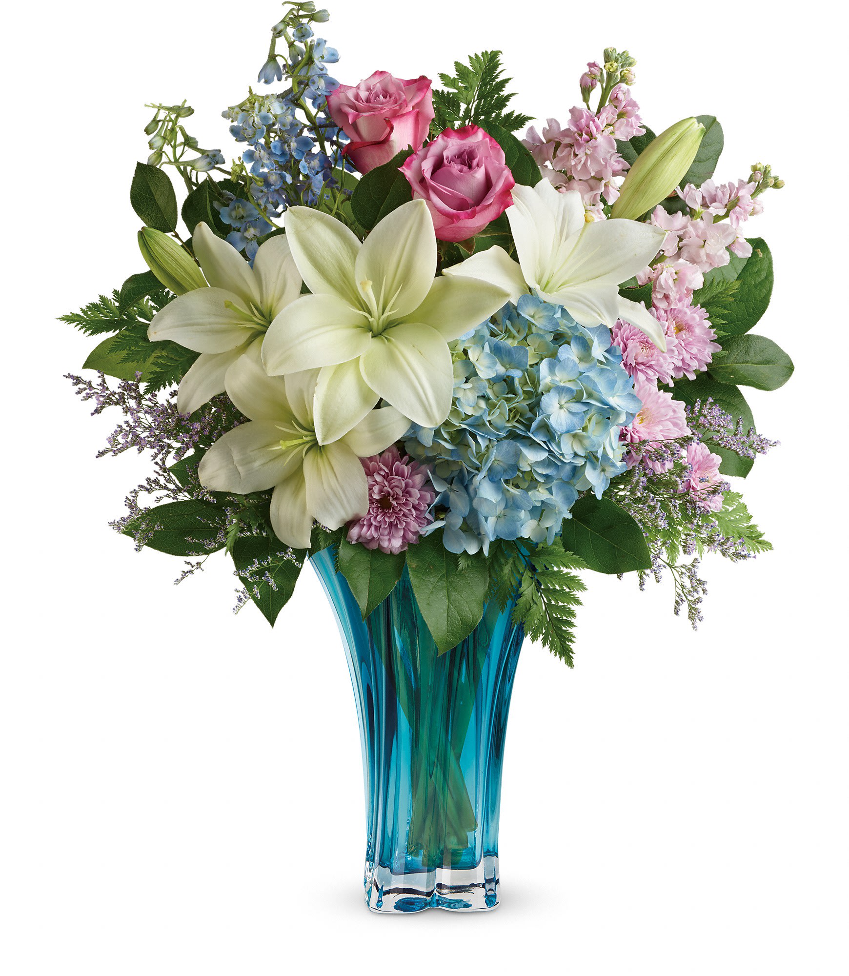 Heart's Pirouette Bouquet - This arrangement features blue hydrangea, lavender roses, white asiatic lilies, light blue delphinium, light pink stock, lavender cushion spray chrysanthemums, leatherleaf fern, and lemon leaf. Delivered in a Heart's Pirouette vase. Approximately 19 1/2&quot; W x 23&quot; H