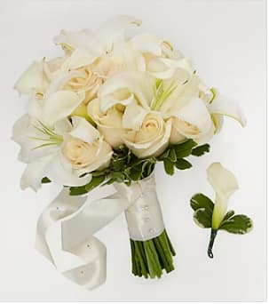 Ivory Inspiration Bridal Package: Bride &amp; Groom - The perfect solution for the modern bride, this collection of hand-tied bouquets and floral accents has been hand gathered from select floral farms to create the wedding of your dreams. Picked fresh for you, Mona's Accents has everything you need to make your style statement on the big day. This package includes the following: 1 Hand-tied Bride's Bouquet consisting of white Oriental Lilies, white mini calla lilies, and cream roses, and 1 Groom's Boutonniere consisting of a single white mini calla lily. Other colors may be available upon request. This is not available for same day delivery.