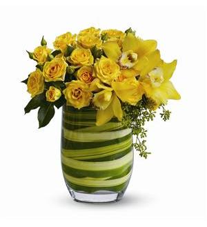 Rising Sun Rising Sun - Just as the sun lights up the day, this dazzling bouquet of yellow blooms such as cymbidium orchids and spray roses – delivered in a clear glass vase lined with leaves – will bring sunshine into someone’s life.