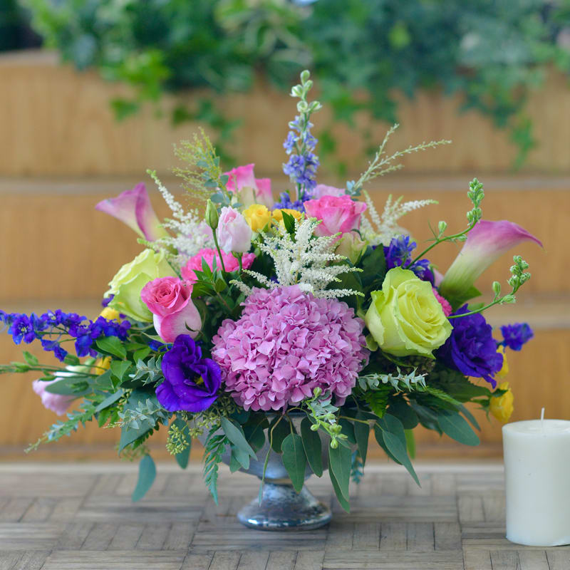 Soft Elegance Soft Elegance - Show off this beautiful centerpiece and wow your friends and loved ones! This colorful arrangement will bring smiles all around!