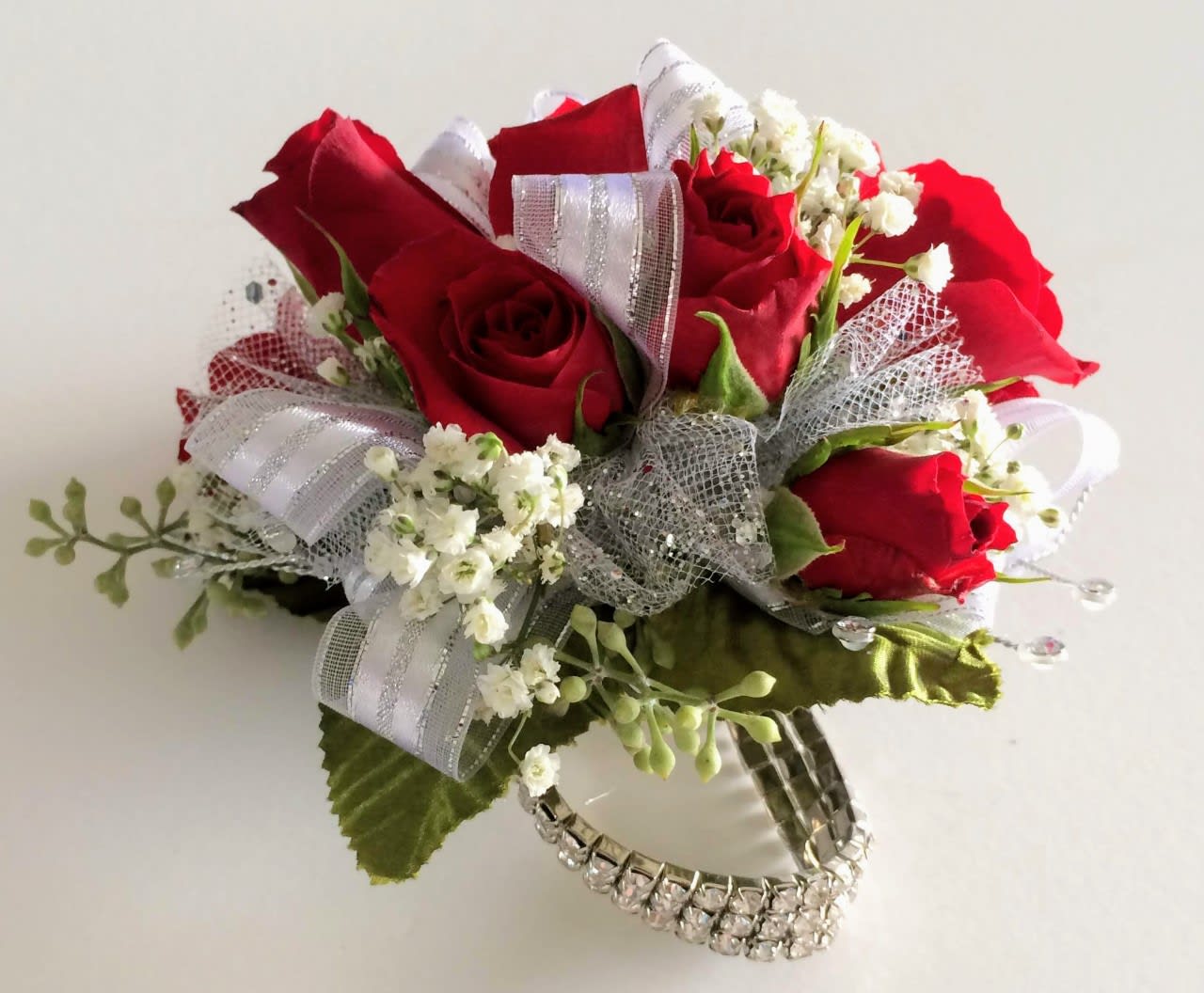 Red Rose Wristlet White Trim - Whether is prom, homecoming or a very special occasion your date will love this artfully crafted wristlet fashioned with a keepsake rhinestone bracelet. 