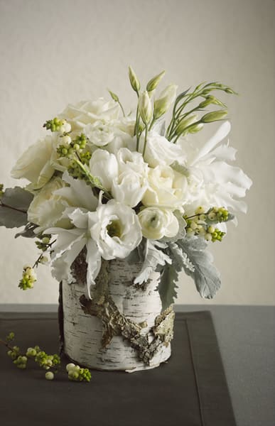 White Birch  - All white Christmas Flowers mixed with Christmas Greens, Berries, and White Accents Arranged in Birch Container. 