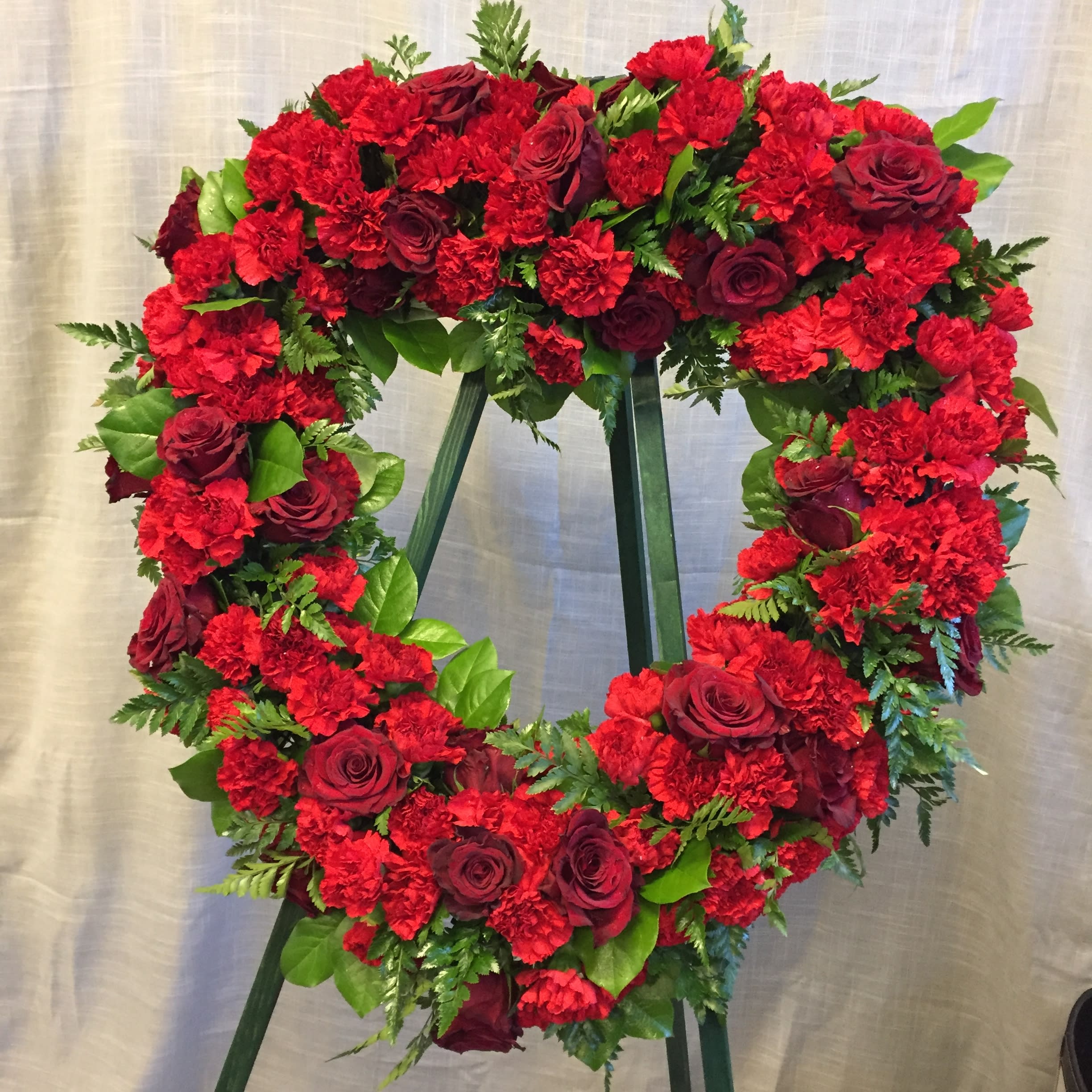 Red Open Heart on Stand - All red flowers in an open heart design delivered on a standing easel. Approximately 24&quot; across and standing approximately 5ft tall.