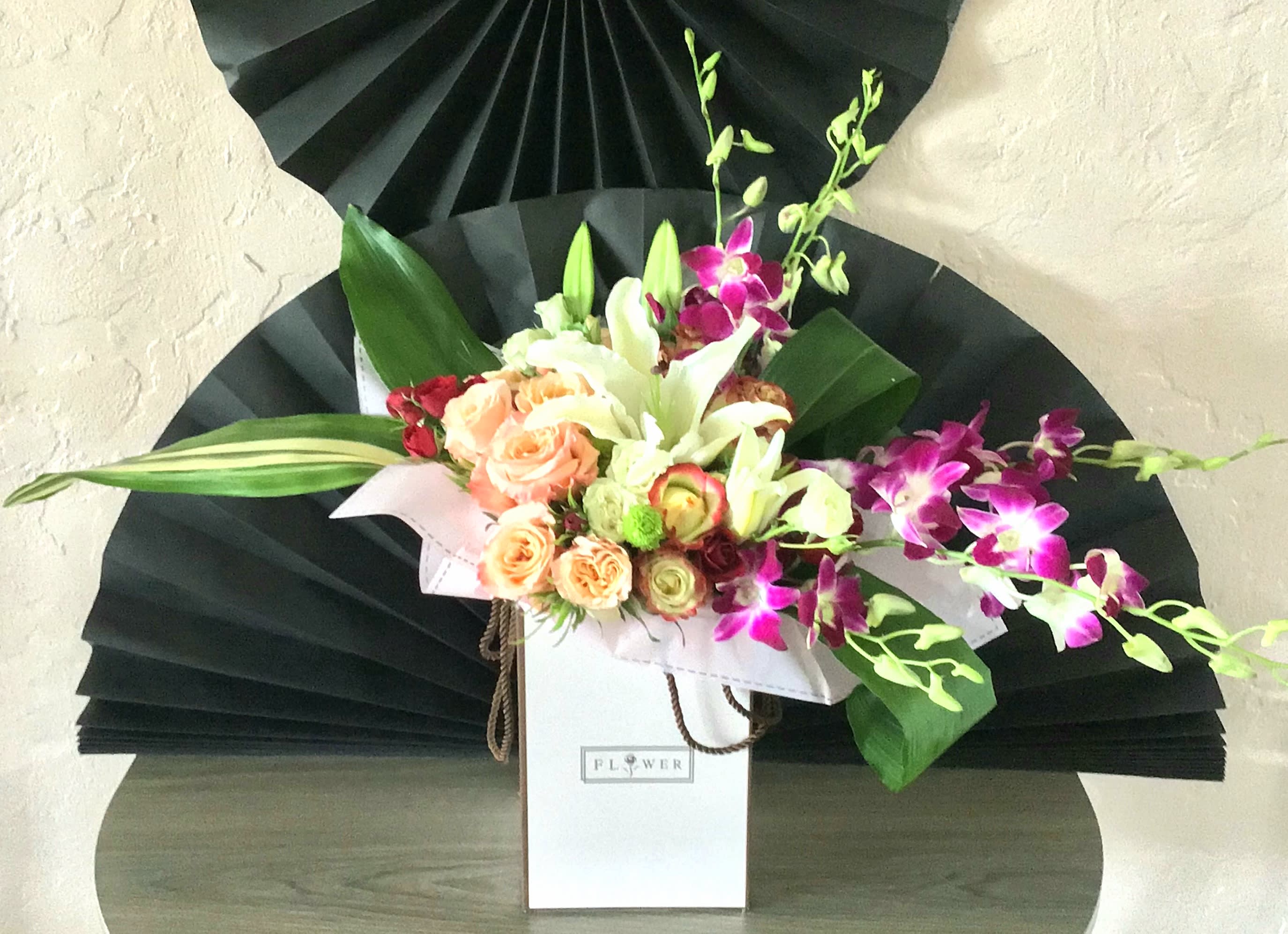 Paradise Passion Paradise Passion - Stunning arrangement of Roses Orchids And Lilies.