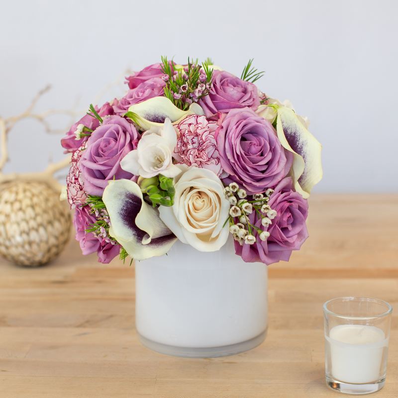 Mixed Purple & White Blooms Mixed Purple & White Blooms - This beautiful mixed floral arrangement is sure to bring a smile to anyone's face. Containers come in clear, white, black and leaf line. It's possible that some days we may not have the exact flowers depending on the season, or exact container specified on the arrangement's description. When this is the case, our bouquets are made with flower substitutions or delivered in a different vase than expected by using substitutions of an equal or higher value. If you'd prefer no substitutions, please send an email or call us after placing your order. Please give us at least three days notice if you're looking for an arrangement with no substitutions.
