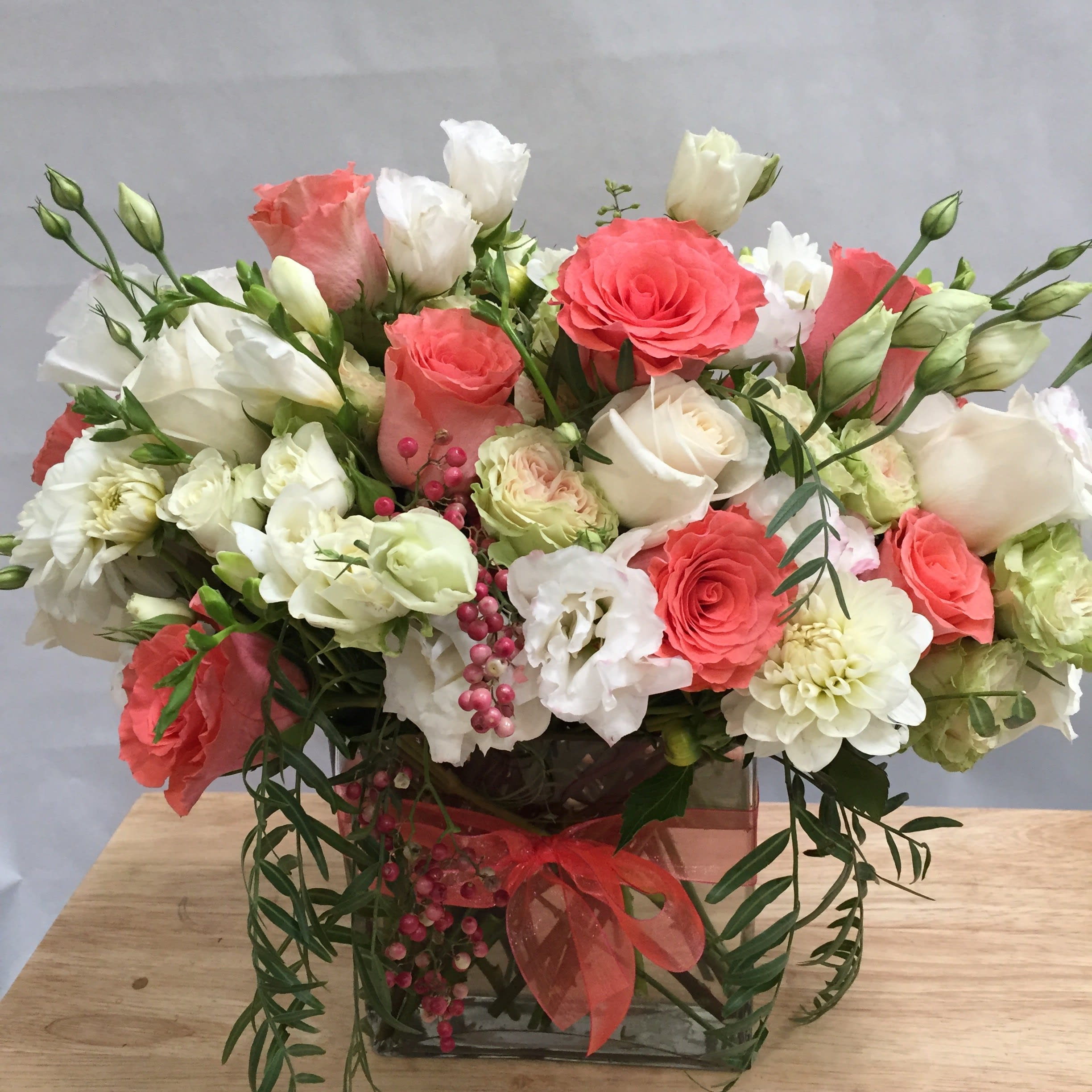 Coral Cashmere - This designer's choice arrangement is overflowing with mixed coral and white roses along with other beautifully toned elements.   *It's possible that some days we may not have the exact flowers depending on the season, or exact container specified on the arrangement's description. When this is the case, our bouquets are made with flower substitutions or delivered in a different vase than expected by using substitutions of an equal or higher value. If you'd prefer no substitutions, please send an email or call us after placing your order. Please give us at least three days notice if you're looking for an arrangement with no substitutions. 