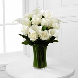 The FTD® Sweet Solace™ Bouquet The FTD® Sweet Solace™ Bouquet - The FTD® Sweet Solace™ Bouquet is a divinely elegant arrangement that encourages peace and offers your sympathy. Brilliant white roses and calla lilies are simply set amongst lush greens in a clear glass gathering vase to create a meaningful gift that will help your special recipient through this trying time of grief and loss.