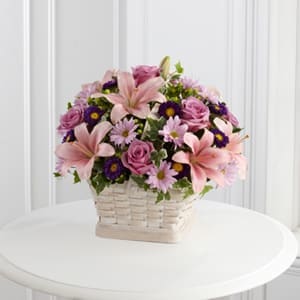 The FTD® Loving Sympathy™ Basket -  The FTD® Loving Sympathy™ Basket is a wonderful way to convey your condolences for their loss. Lavender roses, pink Asiatic lilies, lavender daisies, purple matsumoto asters, green hypericum berries and lush greens are sweetly arranged in a square whitewash basket to create a lovely way to offer you caring kindness during this trying time. 