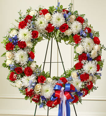 Serene Blessings Red, White & Blue Standing Wreath Serene Blessings Red, White & Blue Standing Wreath - Product ID: 91311 This beautiful red, white and blue wreath is a dignified expression of your feelings of love and care for a beloved veteran or patriot. Exquisitely crafted by our expert florists, it features the freshest red and white roses, blue delphinium and more, creating an unforgettable tribute to honor their life. Standing wreath arrangement of fresh red and white roses and carnations, blue delphinium and more Accented by vibrant greenery Appropriate for family, friends and business associates to send directly to the funeral home Our florists use only the freshest flowers available, so colors and assortment may vary Large measures approximately 32âH x 32âW without easel Small measures approximately 28"H x 34"W without easel Easel may not be available in all areas