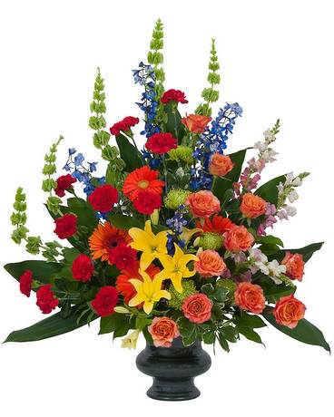 Treasured Celebration Urn Treasured Celebration Urn - A combination of bright color blooms to celebrate the life of your loved one.