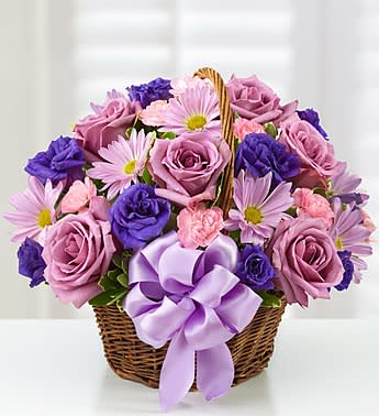 Basket of Blooms - Product ID: 105644  Surprise her with a gift in all her favorite colors! Our beautiful arrangement is filled with roses, lisianthus and daisies in rich shades of purple and lavender. Hand-designed in a charming handled basket and accented with a satin ribbon, it's sure to give her the smile she deserves. Beautiful, hand-crafted basket arrangement of lavender roses, purple lisianthus, lavender daisy poms, light pink mini carnations and variegated pittosporum Artistically designed in an 8&quot;H dark willow handled basket accented with a purple satin ribbon Large arrangement measures approximately 13&quot;H x 15&quot;W Medium arrangement measures approximately 12&quot;H x 14&quot;W Small arrangement measures approximately 11&quot;H x 14&quot;W Picked at the peak of perfection delivered fresh to their door Our florists hand-design each arrangement, so colors, varieties and container may vary due to local availability