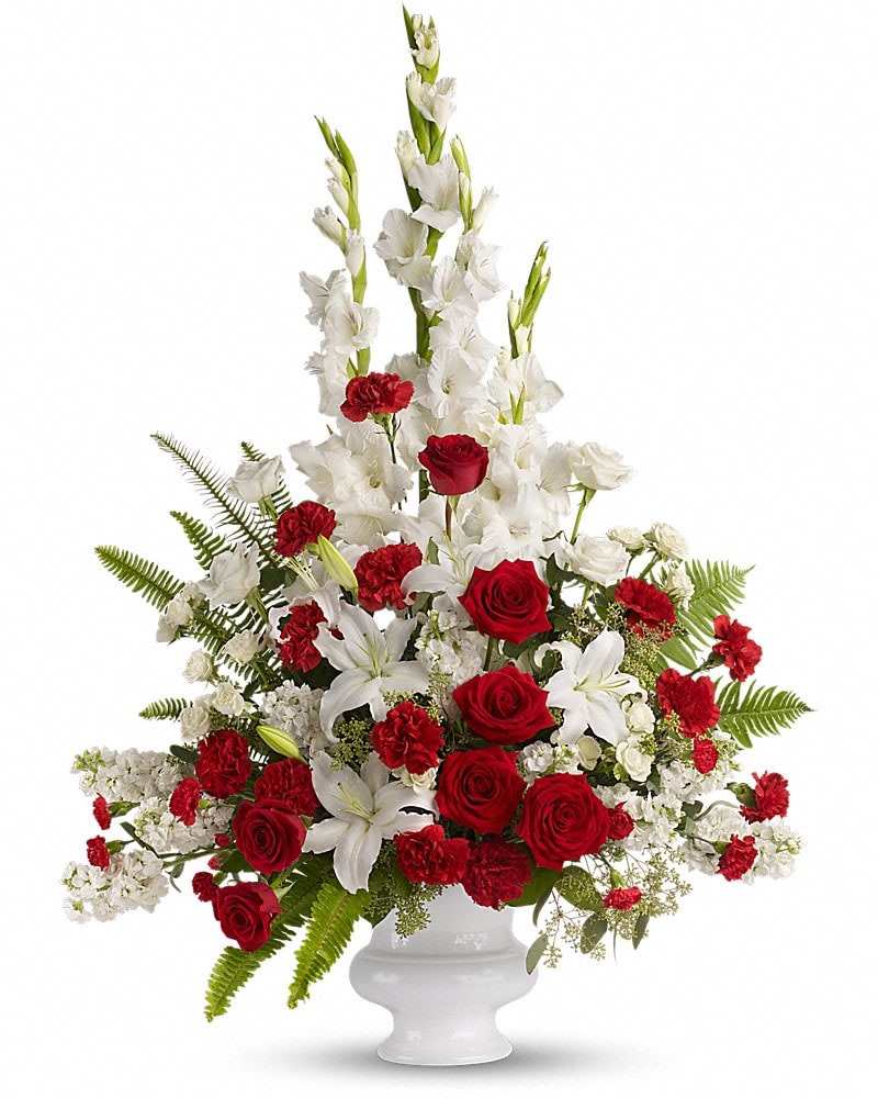 Memories to Treasure - For the sweet spirits who touch our lives a classic pairing of red and white that is both vibrant and respectful. Beautifully contained in a white urn. A mix of fresh flowers such as red and white roses oriental lilies graceful gladioli carnations and fragrant eucalyptus. Beautifully presented in a white urn.