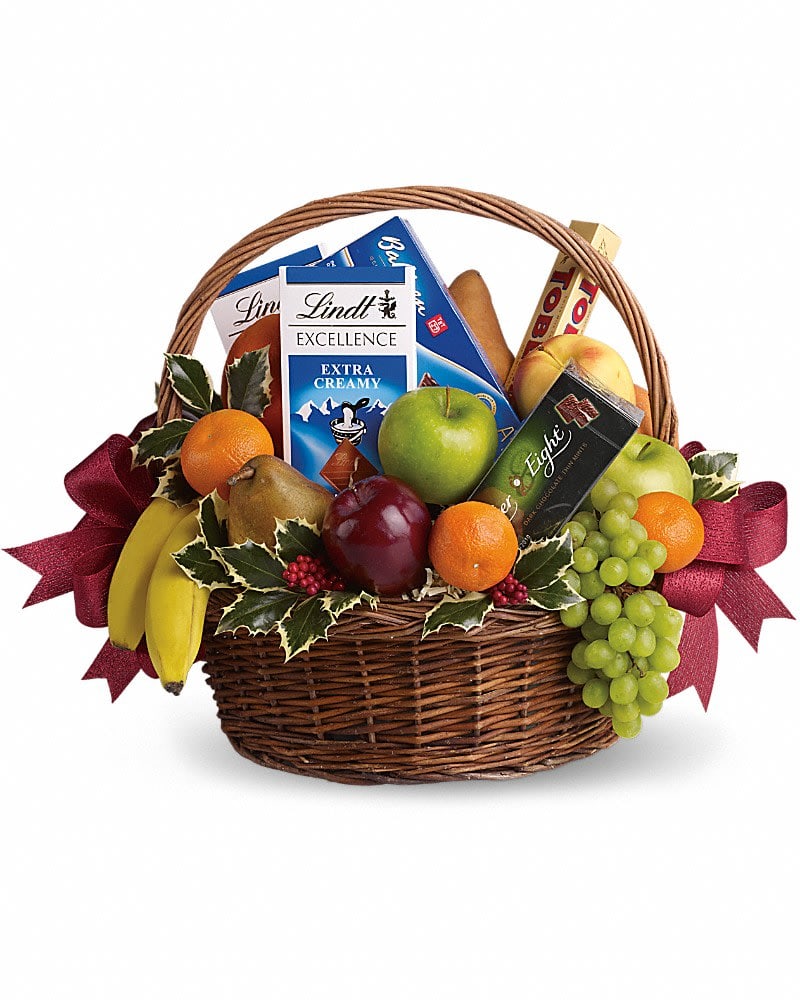 Fruits and Sweets Christmas Basket - Even if your gift list seems like it&#039;s endless this year, sending anyone a sweet holiday gift is beautifully easy. This basket is fresh, festive and fabulous. Oh, and did we mention delicious? Fresh green, red and yellow apples, bananas, grapes, pears and tangerines are arranged with an assortment of gourmet chocolate bars and cookies. Add Christmas holly and red ribbons and you&#039;ve got one heck of a healthy Christmas gift.