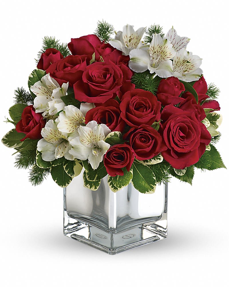 Teleflora&#039;s Christmas Blush Bouquet - Oh come all ye tasteful and send this stylish array of red roses and white alstroemeria in a chic mirrored silver cube. Beautiful and beautifully priced, it is a gift guaranteed to make spirits bright. The stylish Christmas flower arrangement includes red roses, red spray roses and white alstroemeria accented with pittosporum and ming fern.