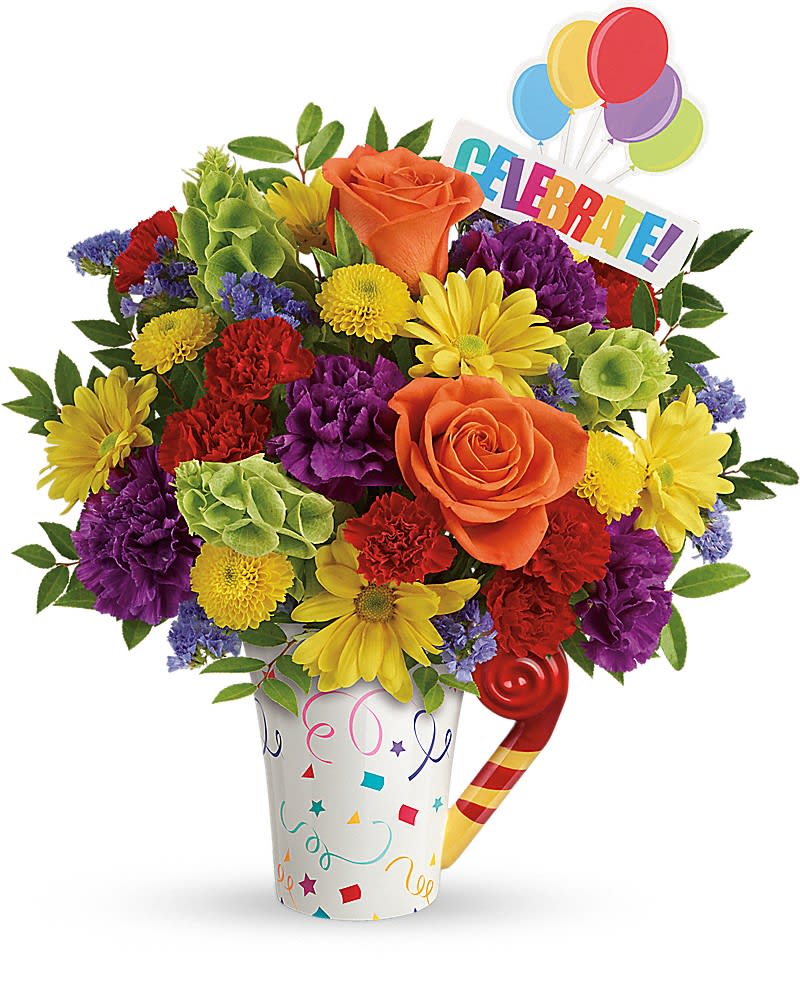 Teleflora&#039;s Celebrate You Bouquet - It&#039;s a party to go! Celebrate life&#039;s special moments with this fun, fabulous mix of roses, carnations and mums, hand-delivered in a festive, food-safe mug that will make their coffee breaks extra fun. Perfect for any festive occasion, from birthday parties to graduations to retirements! This delightful gift bursts with orange roses, purple carnations, red miniature carnations, yellow button spray chrysanthemums, yellow daisy spray chrysanthemums, bells of Ireland, blue sinuata statice, and huckleberry. Delivered in a Cheers to You mug.