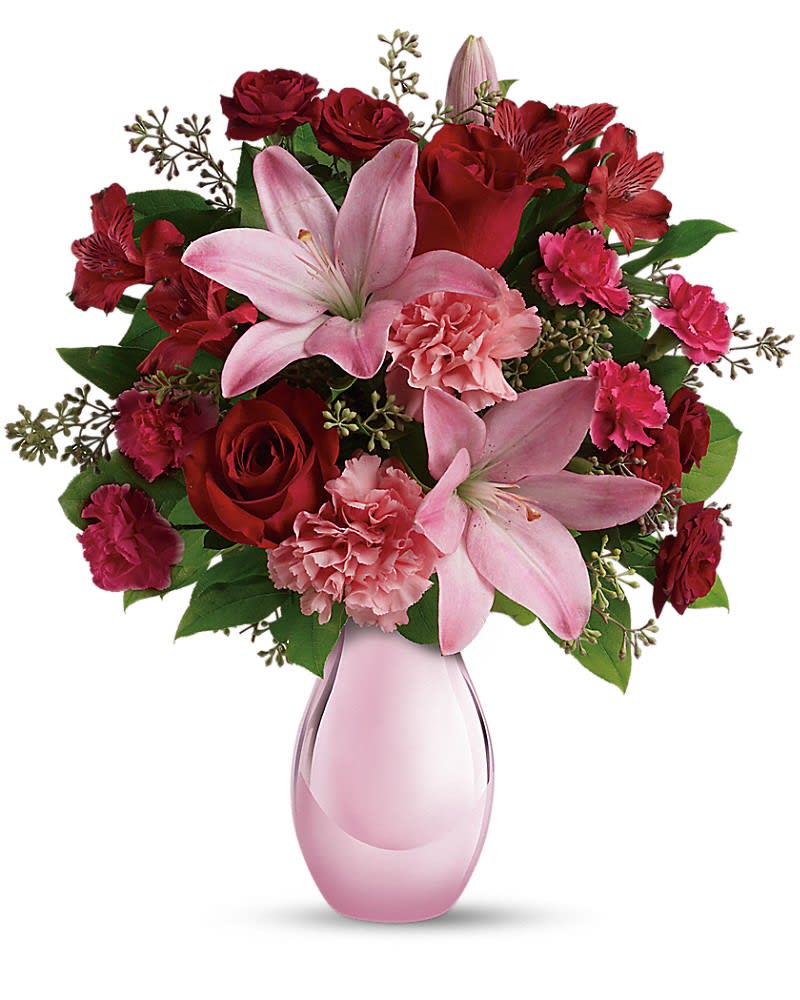 Teleflora&#039;s Roses and Pearls Bouquet - She&#039;ll be delighted when she receives this gorgeous array of roses, lilies and more artistically arranged in a dazzling pink reflections vase. It&#039;s a gorgeous gift that she&#039;ll love now and cherish forever. This gorgeous bouquet includes red roses, red spray roses, pink asiatic lilies, red alstroemeria, pink carnations and pink miniature carnations accented with assorted greenery. Delivered in Teleflora&#039;s exclusive pink reflections vase.
