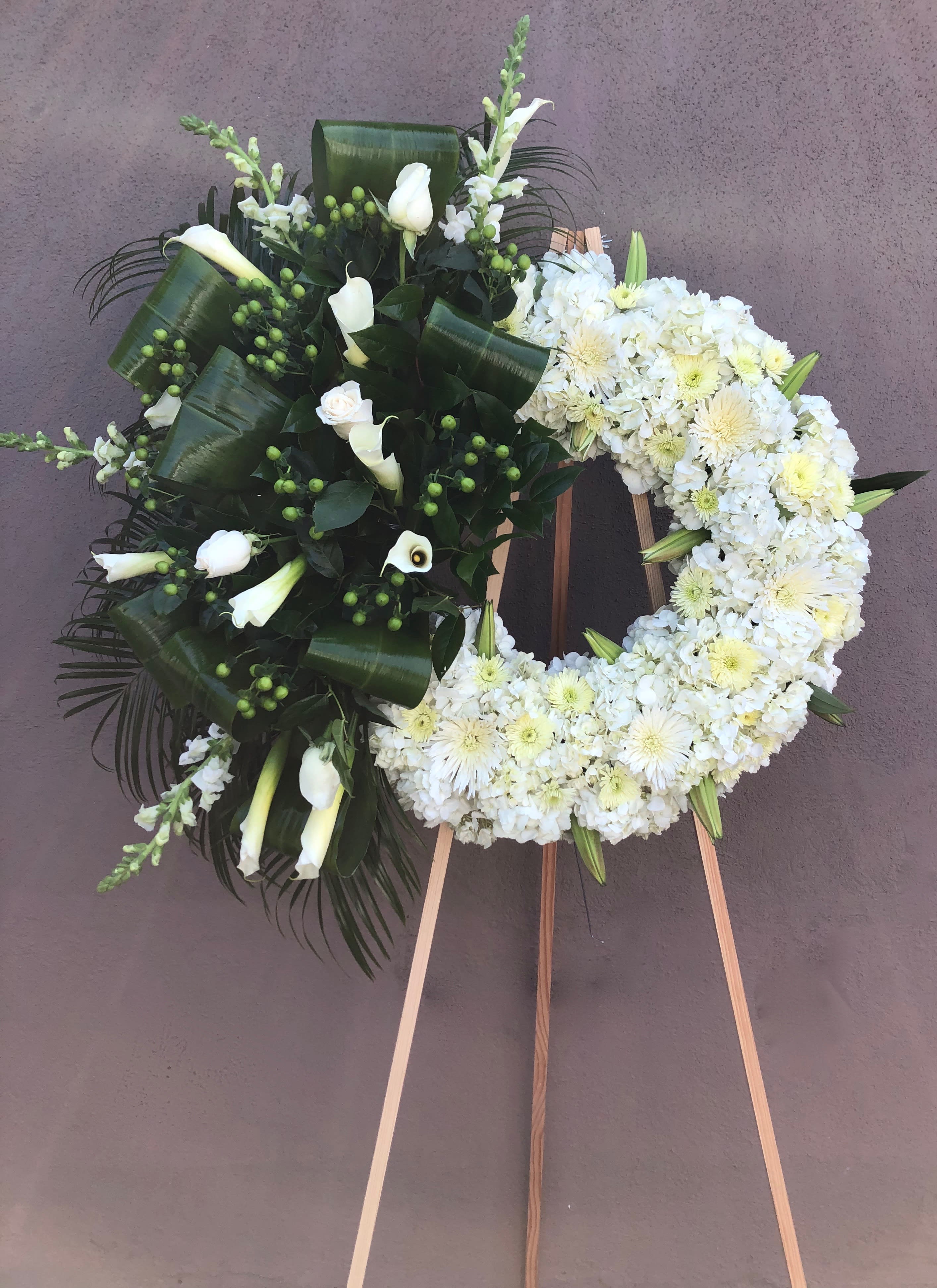 Elegant Wreath  - Medium  wreath with hydrangeas, lilies, calla lilies, snapdragon, pom pom, spider, green coffee beans and tropical leafs   We can incorporate different colors to this  arrangement. Feel free to reach out to us at any time and we will gladly help you.