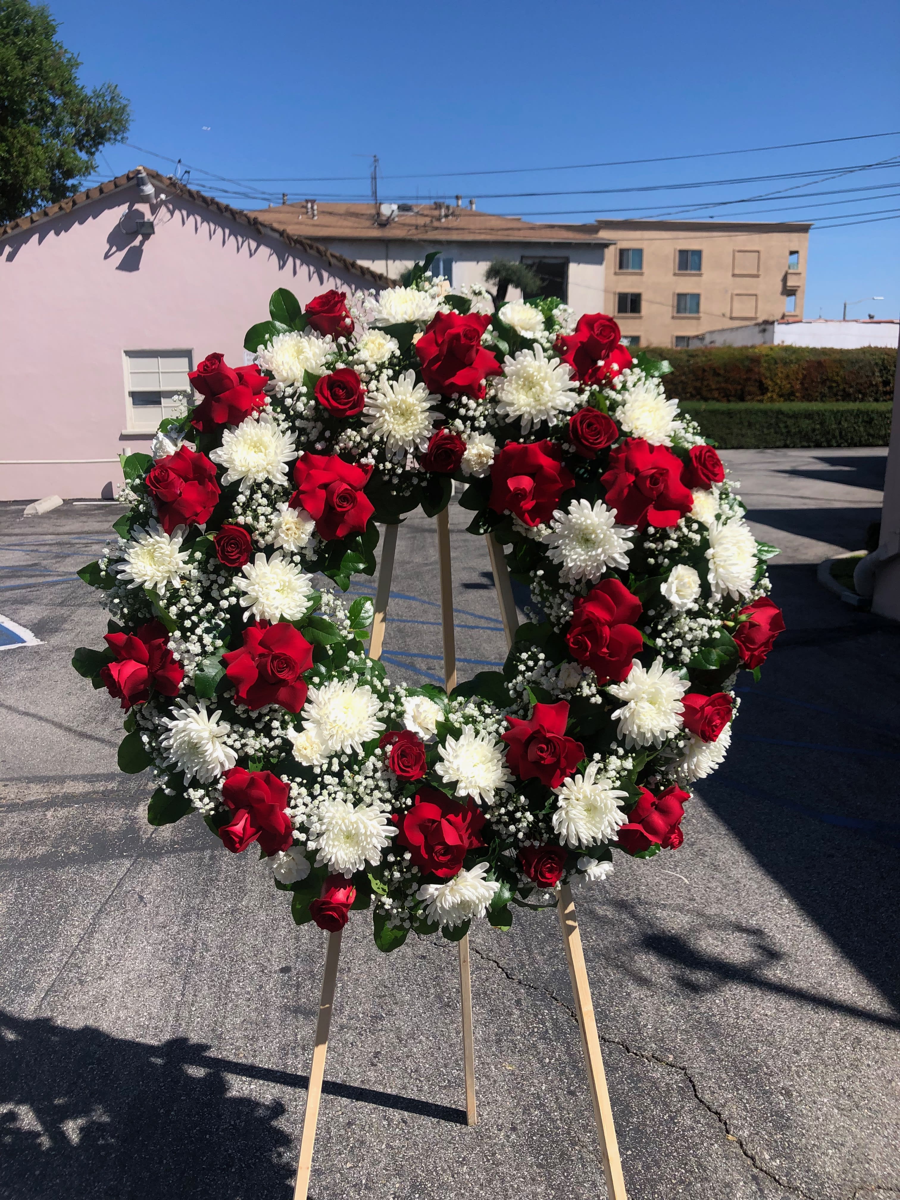 Red oriental wreath Red oriental wreath - Large wreath with open roses, closed roses, pom pom, tropical leafs babies breath spider flowers, We can make this arrangement in any color. Feel free to reach out to us at any time and we will gladly help you.