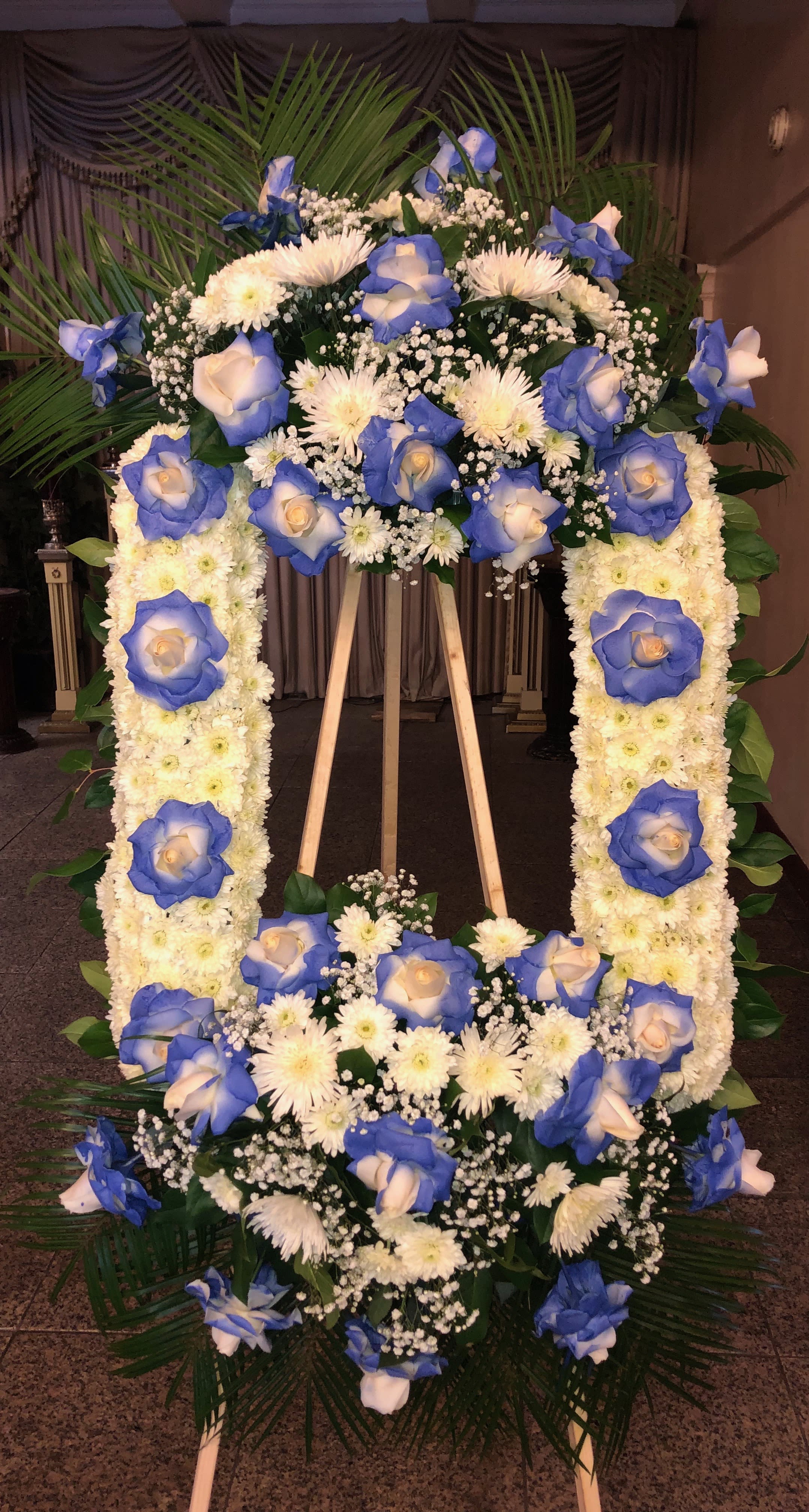 Light Blue 16x20 frame Light Blue 16x20 frame - 16X20 Flower frame with two bouquets. Light blue picture frame with roses, tropical leafs, and a bouquet with roses, , babies breath and lilies. Note the arrangement can be made in other colors as well as size