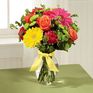 The FTD® Bright Days Ahead Bouquet - Celebrating life with colorful blooms that inspire and delight, this flower bouquet is ready to create a happy moment for your recipient that they will never forget. Orange roses, hot pink gerbera daisies, yellow gerbera daisies, hot pink carnations, green button poms, bupleurum, and lush greens mingle together to create a sunlit display while seated in a classic clear glass vase tied at the neck with a yellow satin ribbon for a sweet affect. A perfect get well, happy birthday, or congratulations gift! GOOD bouquet includes 12 stems. Approx. 14&quot;H x 11&quot;W. BETTER bouquet includes 16 stems. Approx. 15&quot;H x 12&quot;W. BEST bouquet includes 20 stems. Approx. 16&quot;H x 12&quot;W.
