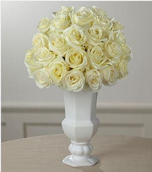 The FTD® Special Blessings™ Bouquet - Elegant simplicity defines this extraordinary floral tribute that beautifully expresses what is in your heart at a time of profound sadness. An exquisite cloud of heavenly white roses, simply arranged by a local FTD artisan florist in a classic white ceramic urn vase, makes a stunning addition to a wake, funeral or graveside service. Its loveliness can provide much appreciated and long remembered comfort when sent to the family home.  Your purchase includes a complimentary personalized gift message.