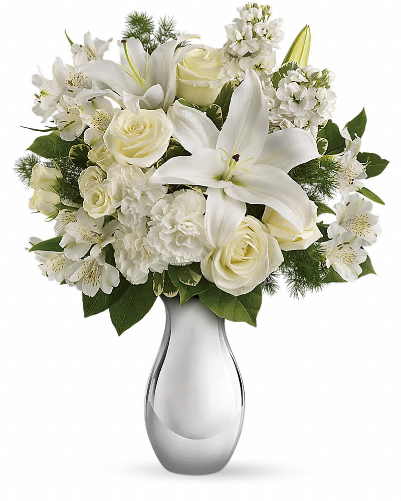 Teleflora&#039;s Shimmering White Bouquet - All is calm, all is white in this exquisite bouquet featuring white roses, lilies, alstroemeria and stock in a sparkling silver reflections vase. What a beautiful gift during this beautiful season. They&#039;ll be thrilled. The gorgeous bouquet includes white roses, white spray roses, white oriental lilies, white alstroemeria and white stock accented with assorted greenery.