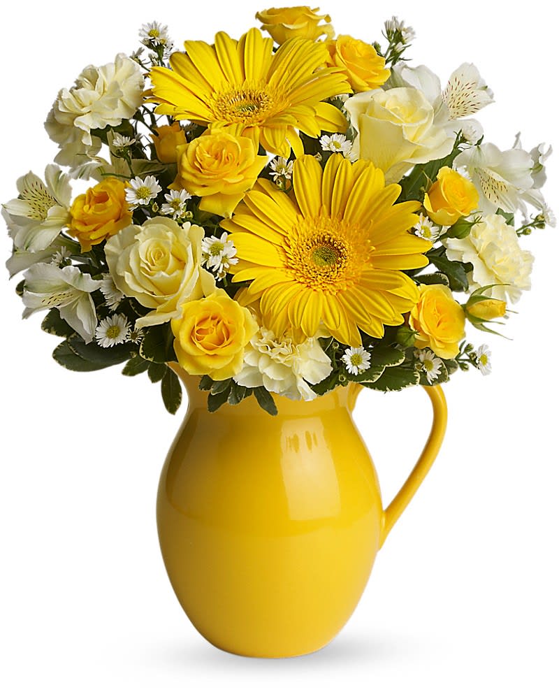 Teleflora&#039;s Sunny Day Pitcher of Cheer - This bouquet is just bright for any occasion! A bright and sunny medley of flowers is hand-delivered in a brilliant ceramic pitcher that can be joyfully used over and over again. Light yellow roses and carnations, yellow spray roses, gerberas and alstroemeria, white monte cassino asters and pittosporum arrive in an exclusive yellow keepsake pitcher. Now that&#039;s what we call pitcher perfect!