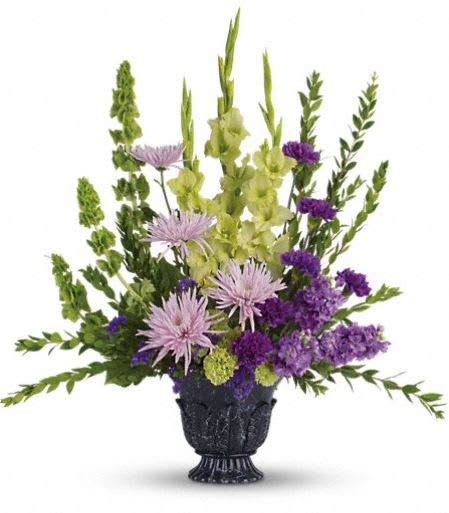 T268-1A  Teleflora's Cherished Memories - This ethereally lovely bouquet of green gladioli, lavender stock, purple carnations and more in a timeless-tribute urn is a stunning choice for the memorial service. The serenely beautiful bouquet includes green gladioli, lavender stock, green carnations, purple carnations, lavender spider chrysanthemums, bells of Ireland and purple sinuata statice, accented with assorted greenery. Delivered in a timeless tribute urn. Approximately 29&quot; W x 31&quot; H 
