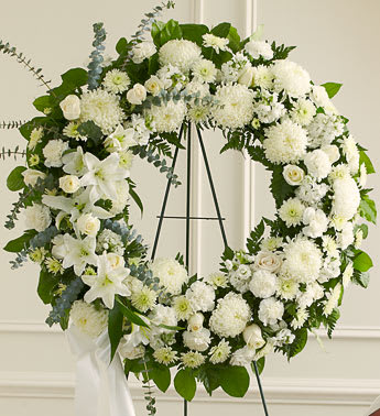 Serene Blessings White Standing Wreath - Product ID: 91315   Sometimes, finding the words to show how much a loved one will be missed can be very hard. When you select this standing wreath of all-white flowers, expertly designed and crafted by one of our local florists, youâre sending an arrangement that reflects all of the respect, love and compassion you want to express during this difficult time. Standing wreath arrangement of fresh white flowers such as roses, football mums, carnations and more Accented by spiral eucalyptus, salal and more Appropriate for family, friends and business associates to send directly to the funeral home Our florists use only the freshest flowers available, so colors and assortment may vary Large measures approximately 34&quot;H x 34&quot;L without easel Small measures approximately 32&quot;H x 32&quot;L without easel Easel may not be available in all areas
