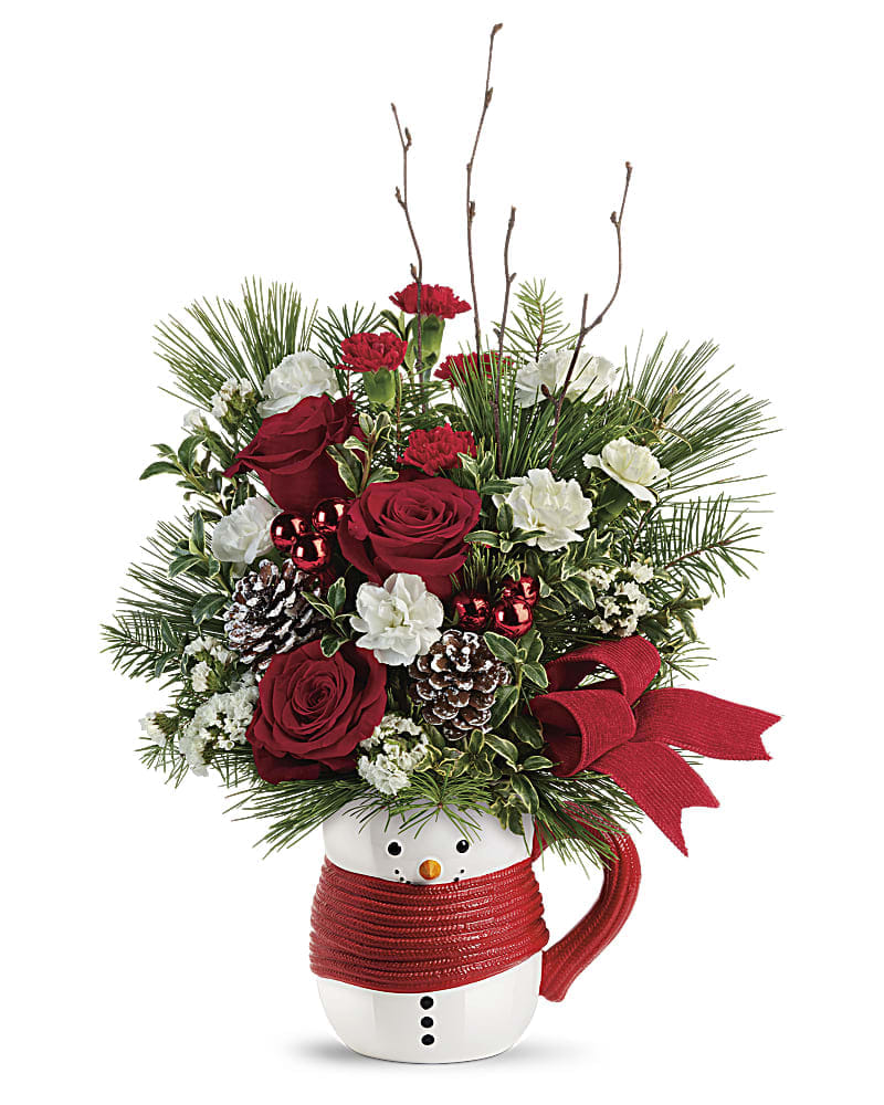 Send a HugÂ® Festive Friend Bouquet by Teleflora - Cozy up to Christmas with this jolly bouquet of winter greens and holiday blooms, hand-delivered in a smiling ceramic snowman mug for years of cocoa-sipping pleasure! This festive friend features red roses, miniature red carnations, miniature white carnations, white sinuata statice, douglas fir, white pine, oregonia, and birch. Delivered in a Send a HugÂ® Snowman Mug.