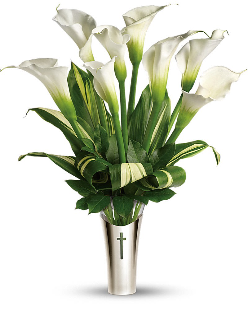 Teleflora's Inspiration Bouquet - The fragrant white calla lilies are breathtaking. The stunning contemporary vase with its cross motif will be a treasured keepsake. A lovely choice for home or service. The gorgeous bouquet includes six large white calla lilies, accented with ti leaves and salal. Delivered in glass vase inside a silver-toned sleeve adorned with a cut-out cross.