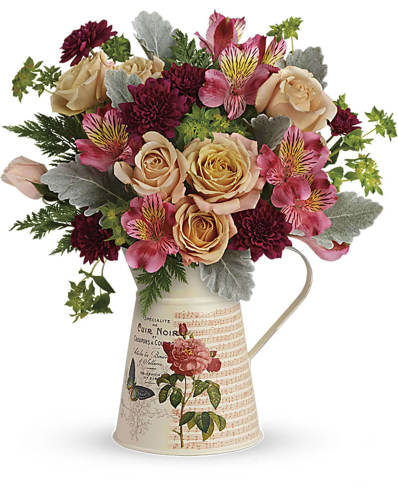 Teleflora's Mod Mademoiselle Bouquet - Straight out of a Parisian flea market, this hand-glazed metal water pitcher brings the perfect vintage touch to a timeless bouquet of peach roses and burgundy mums. Sure to make any mademoiselle smile, especially mom! This beautiful bouquet of peach spray roses, pink alstroemeria, and burgundy cushion spray chrysanthemums is accented with bupleurum, dusty miller, and leatherleaf fern. Delivered in a Mod Mademoiselle pitcher.
