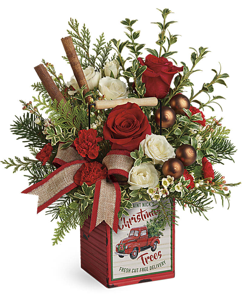 Teleflora's Quaint Christmas Bouquet - Capture the quaint charm of a country Christmas with this vintage-inspired metal cube, arranged with lush holiday roses, fresh winter greens and festive decorations! This vintage-inspired bouquet features red roses, white spray roses, red miniature carnations, white waxflower, flat cedar, noble fir, and oregonia. Delivered in a Merry Vintage Christmas Cube.