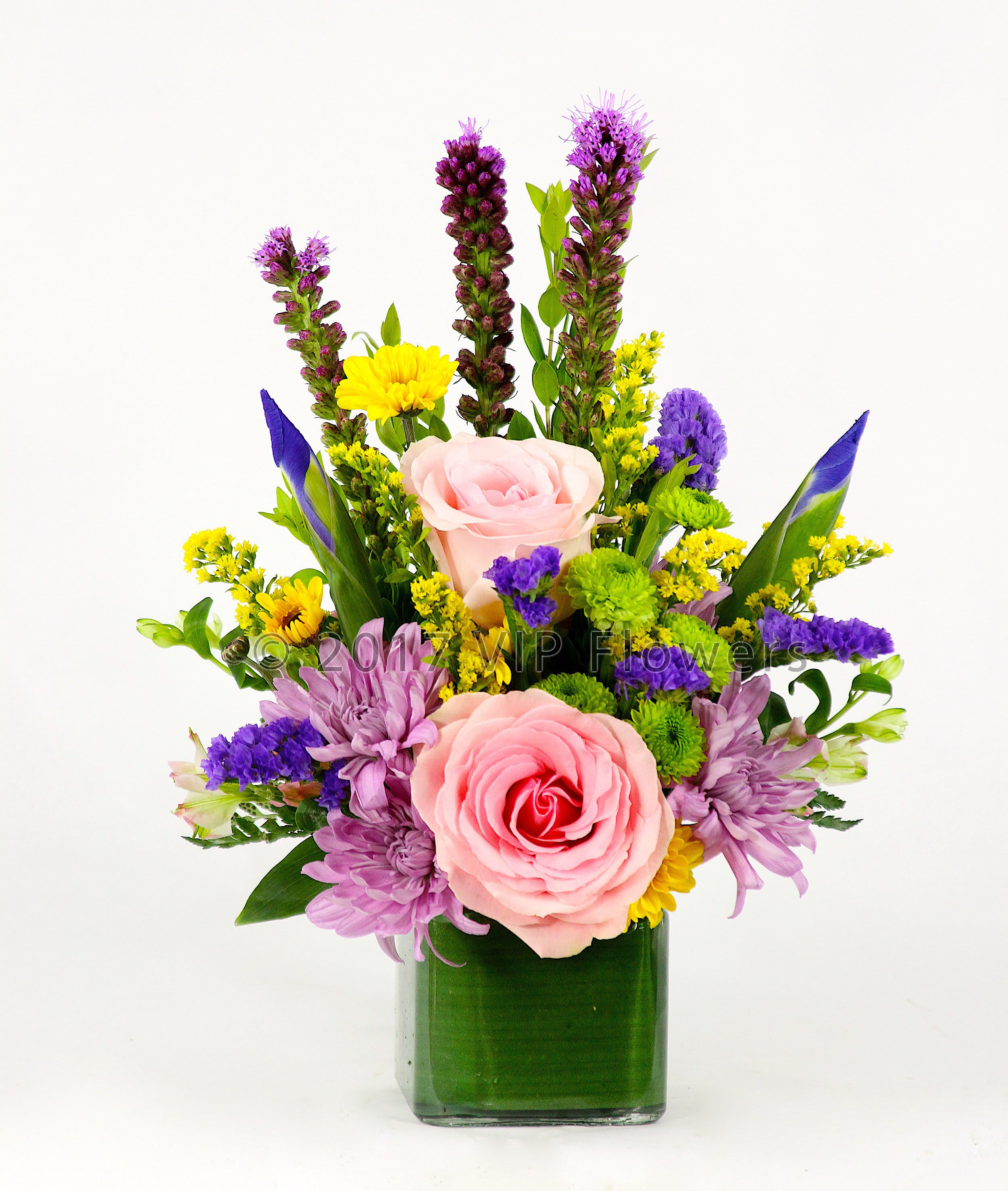 Eventful Surprise - Flowers Included:  Pink Roses Purple Mums Greens Mums Iris Yellow Mums Statice Liatris Seasonal Greens       Substitutions may be necessary to ensure your arrangement or specialty gift is delivered in a timely manner. The utmost care and attention is given to your order to ensure that it is as similar as possible to the requested item (Please note that some flowers and colors may vary due to seasonality.)