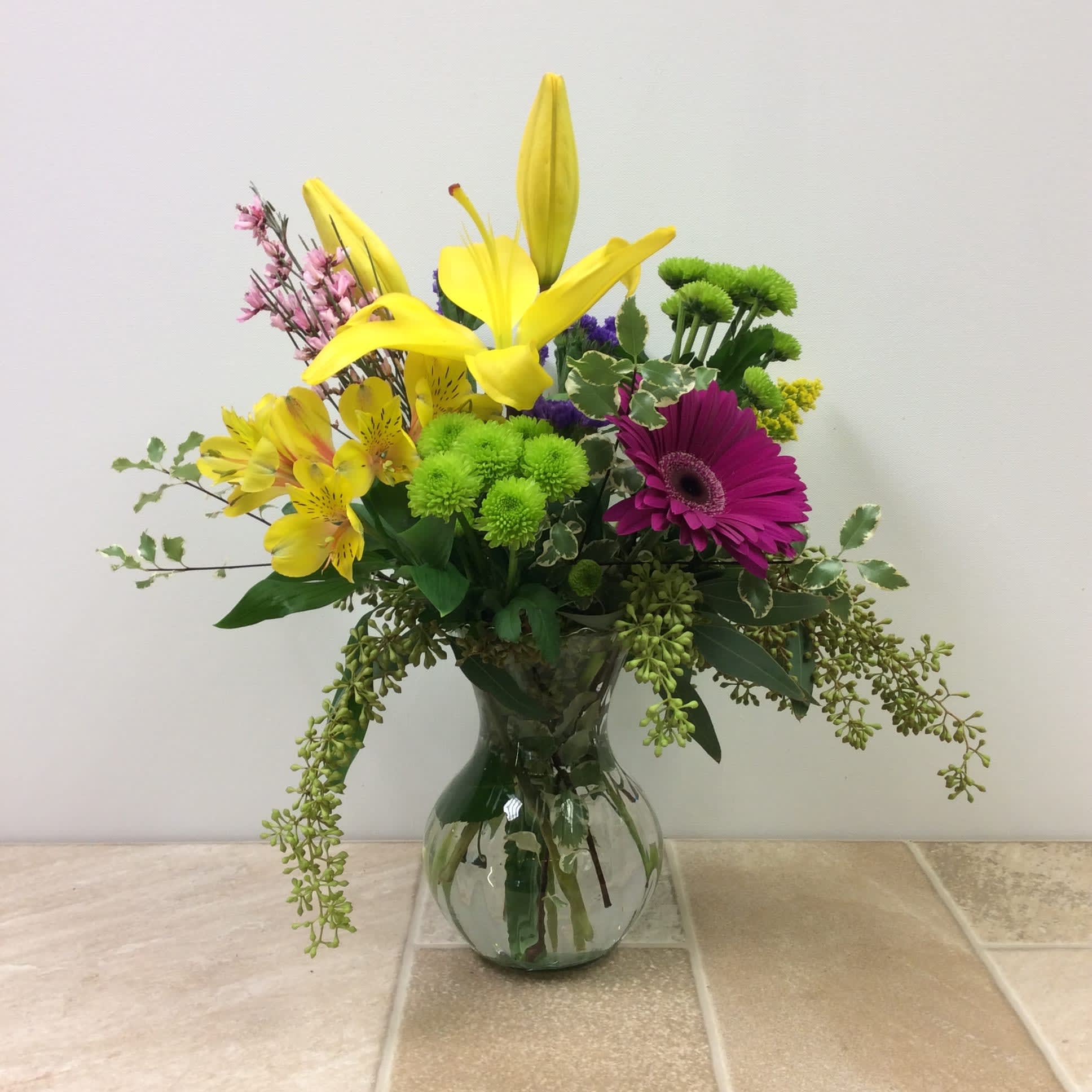 Ella - A pretty clear vase filled with asiatic lilies,alstroemerias,gerbera daisies, fragrant genestra, and eucalyptus.