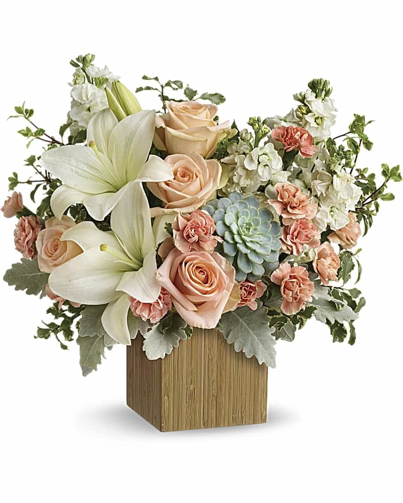 Desert Sunrise Bouquet - Reminiscent of a desert sunrise, this modern mix of peach blooms, white lilies and succulents is a super chic statement in a natural bamboo cube. 