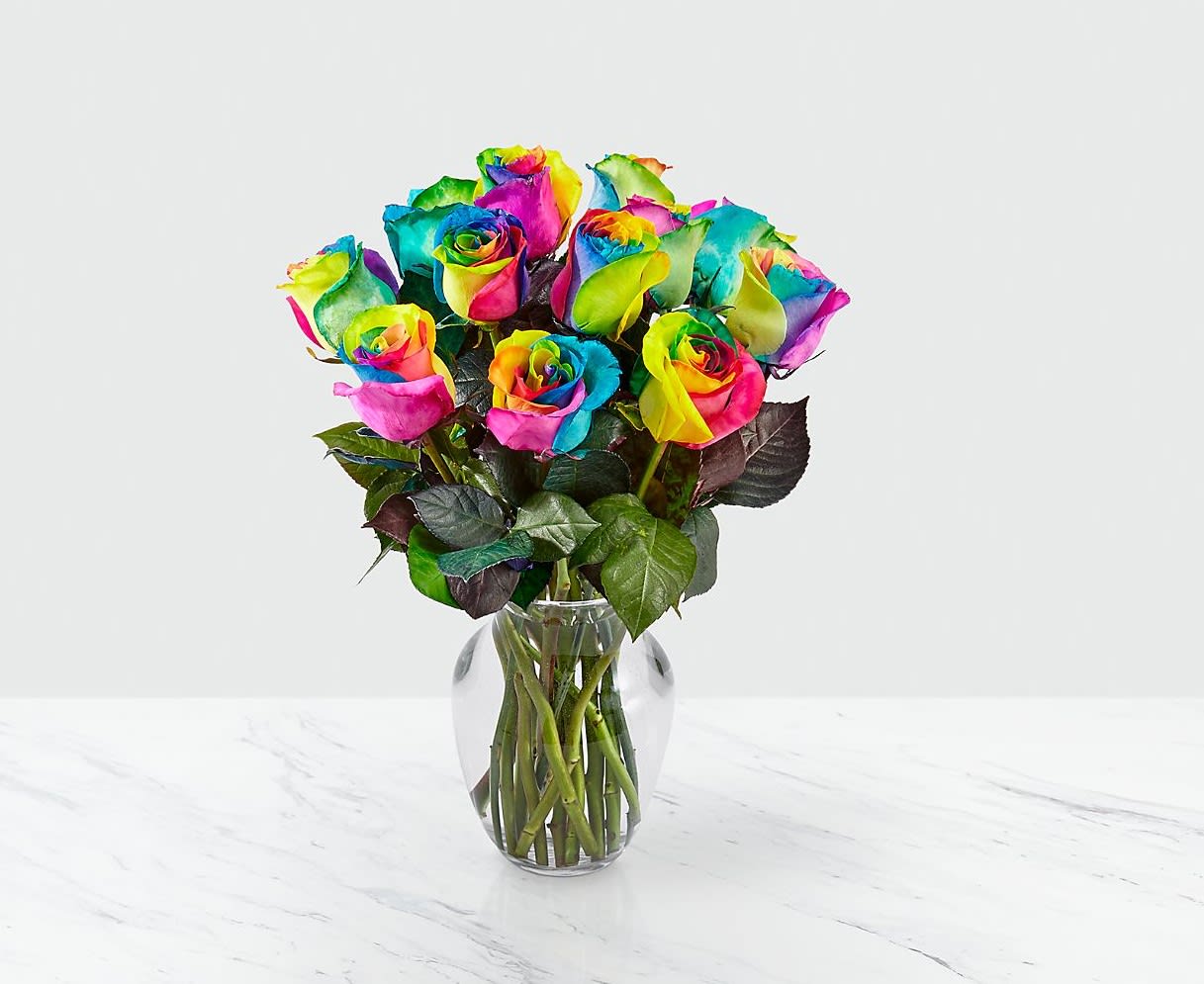 Time to Celebrate Rainbow Rose Bouquet Time to Celebrate Rainbow Rose Bouquet - Picked fresh from the farm to bring your special recipient a bouquet like none other, the Time to Celebrate Rainbow Rose Bouquet is a unique gift they will always remember. Hand gathered in select floral farms, these kaleidoscope inspired roses have been dyed so that each petal displays a different vibrant hue of either yellow, blue, green, purple or pink to create a flower arrangement picked fresh for you to get the party started, making it the perfect gift to send in honor of the next birthday or congratulations celebration. This bouquet includes multi-colored in a purple vase. BETTER bouquet is approximately 19"H x 14"W.
