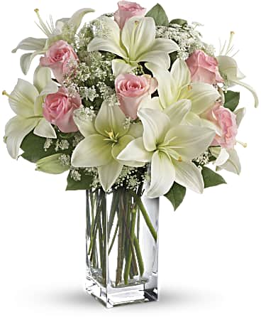 Heavenly and Harmony Heavenly and Harmony - Stunning in its simplicity, this innocent harmony of light pink roses and snow white lilies are a heartfelt way to send your very best. The classic, clear rectangular glass vase keeps the focus on the heavenly beauty of the blooms.