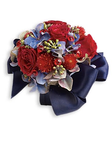 Camera Ready Corsage - Bold and beautiful in ravishing red roses and pale blue hydrangea. Light blue hydrangea, red spray roses and red gomphrena.