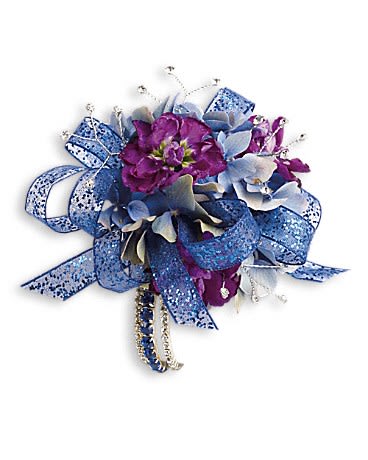 Feel The Beat Corsage Feel The Beat Corsage - Dance the night away in dark, dramatic blue hydrangea and purple stock. Blue hydrangea, purple stock and bear grass with rhinestone touches.