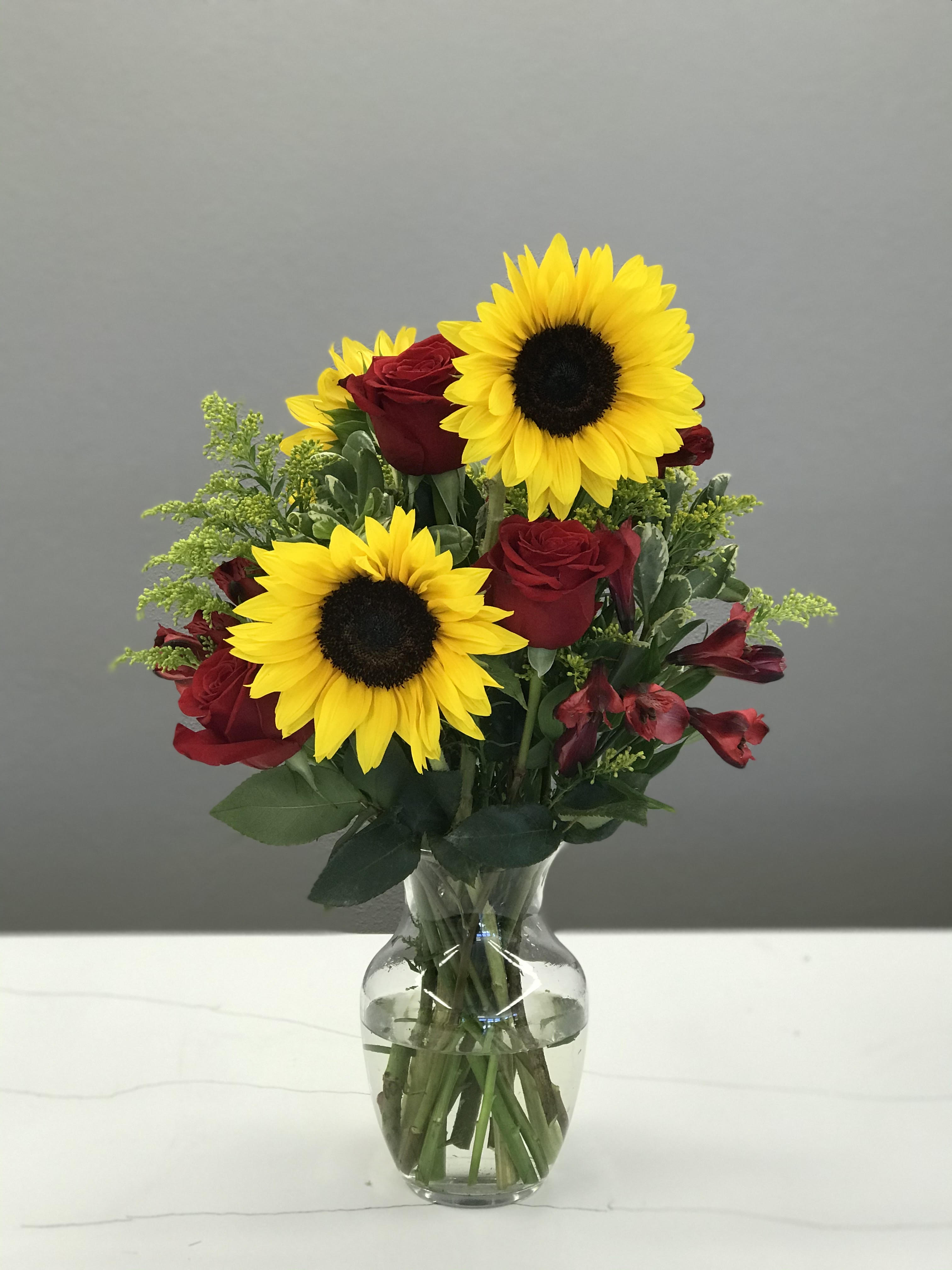 Summer Nights - &quot;Summer loving had me a blast, Summer loving happened so fast&quot;  Celebrate summer romance with big bright sunflowers woven amongst delicate red roses. Life is short- show the one you love just how much you care!! XOXOXO