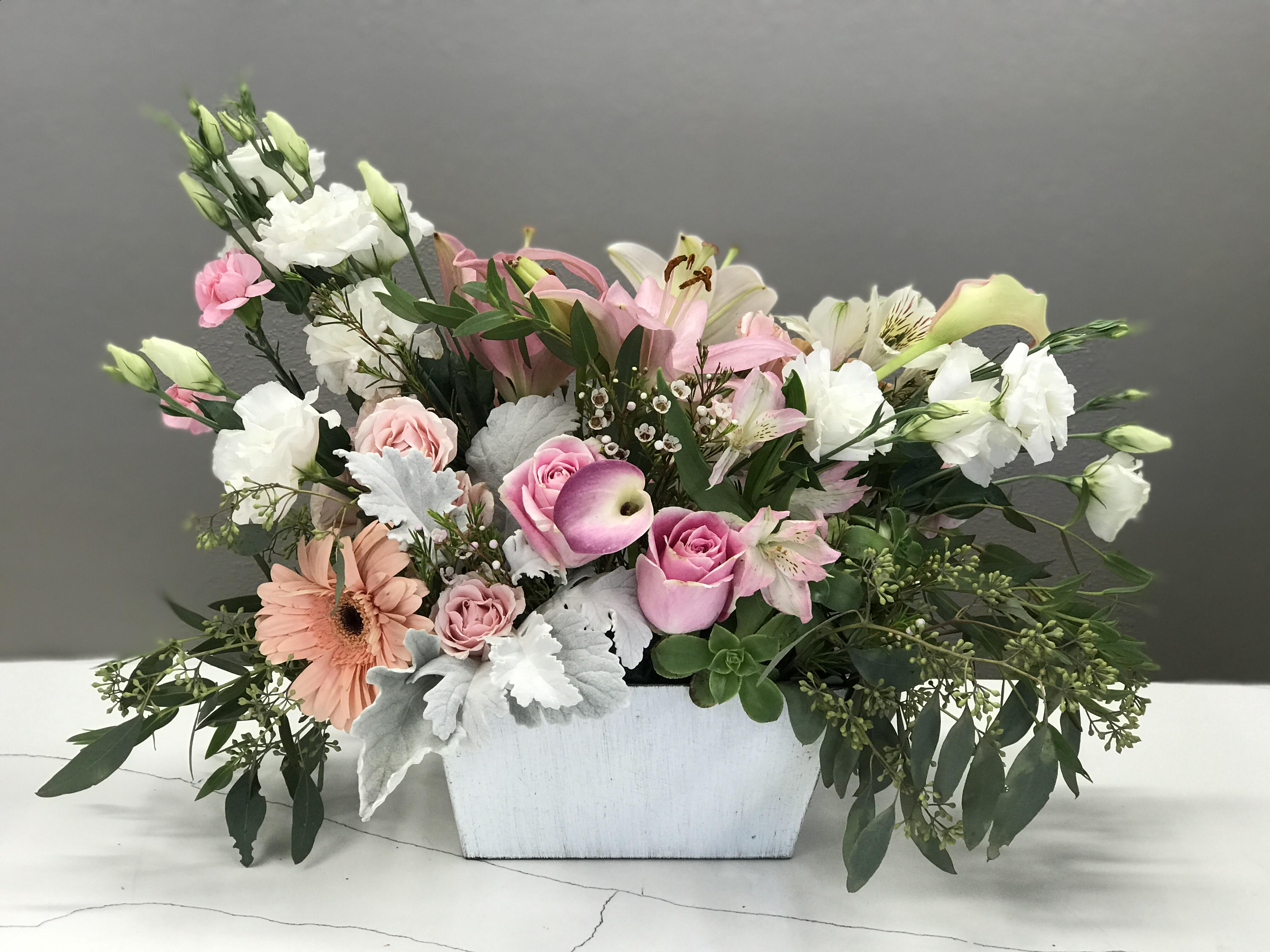 Skirted in Pink - A basket of premium pink and white flowers will show your loved ones just how much you care with simple elegance and tickle of pink.