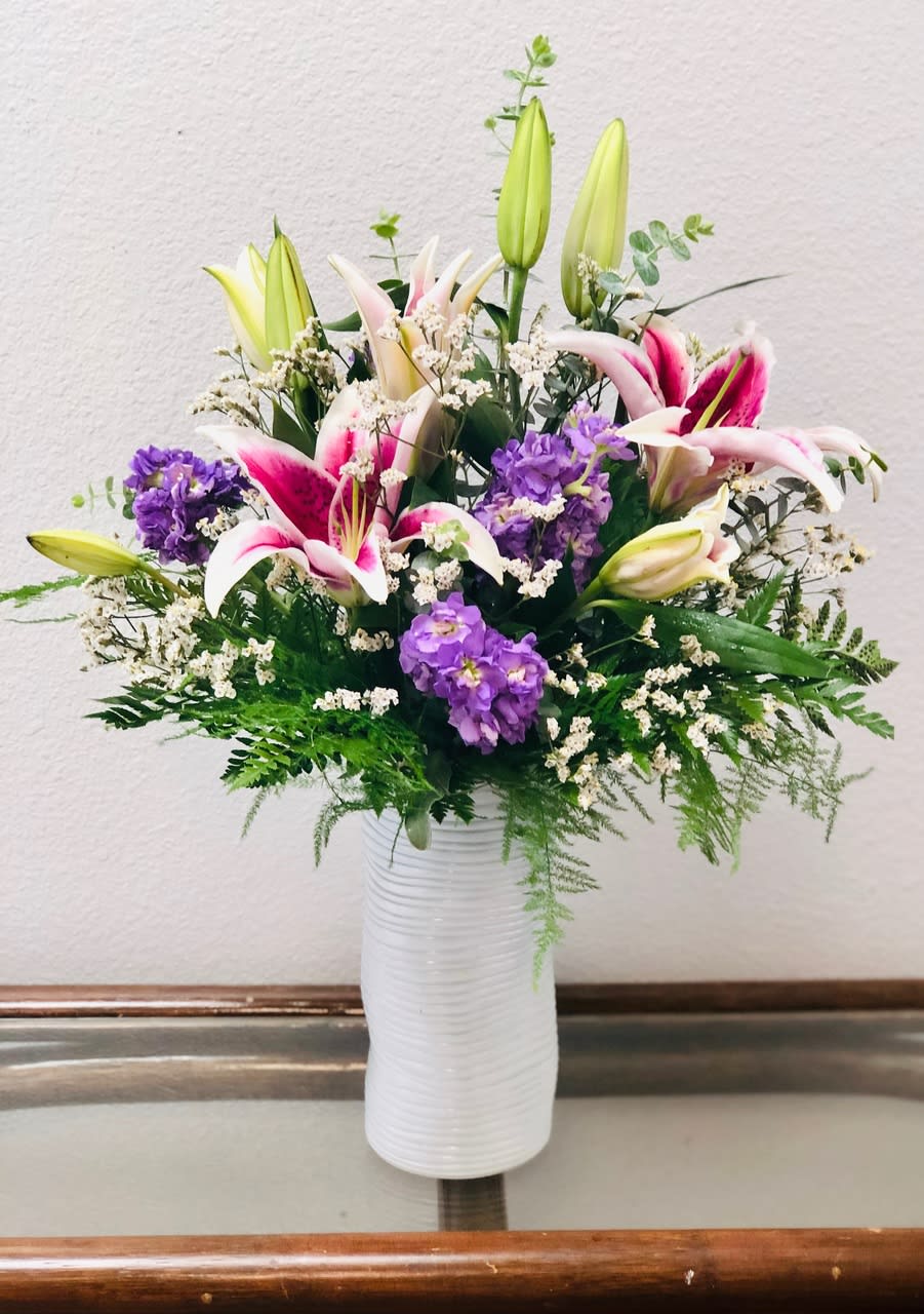 SAFF Heavenly Scent - Fragrant Stargazer Lilies and stock in a contemporary white cylinder.  