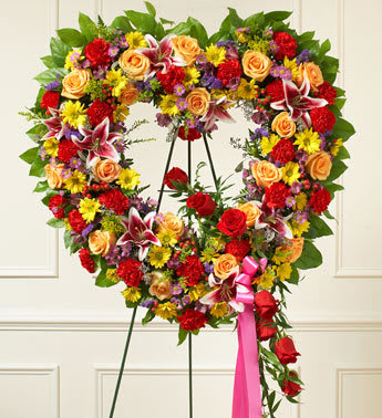 Always Remember Floral Heart Tribute - Bright - Product ID: 91387   When words arenât enough to express your sympathy and love, this open heart standing spray of bright blooms conveys your condolences beautifully. Crafted of beautiful red and peach roses, lilies, carnations, alstroemeria, daisy poms and more Accented by salal, seeded eucalyptus and more Sent directly to the funeral home by family and friends Our florists use only the freshest flowers available so colors and assortment may vary Measures approximately 34&quot;H x 32&quot;L without easel