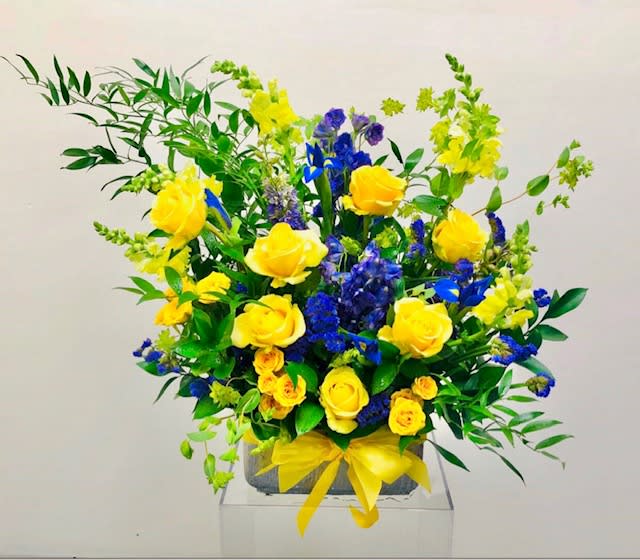 Field of Dreams - Beautiful display of flowers designed as though they are dancing in a field of dreams.  Flowers consist of roses, spray roses, snapdragons, iris, delphinium, and greenery.  Floral arrangement to be placed in a neutral vase.  *Please view policy section regarding substitutions.